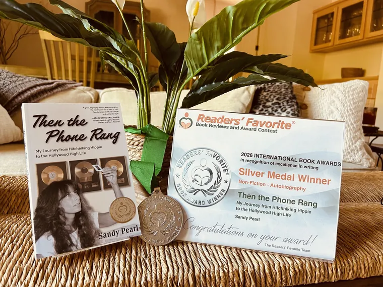 Then the Phone Rang standing beside the Readers' Favorite silver medal and the 2026 International Book Awards certificate